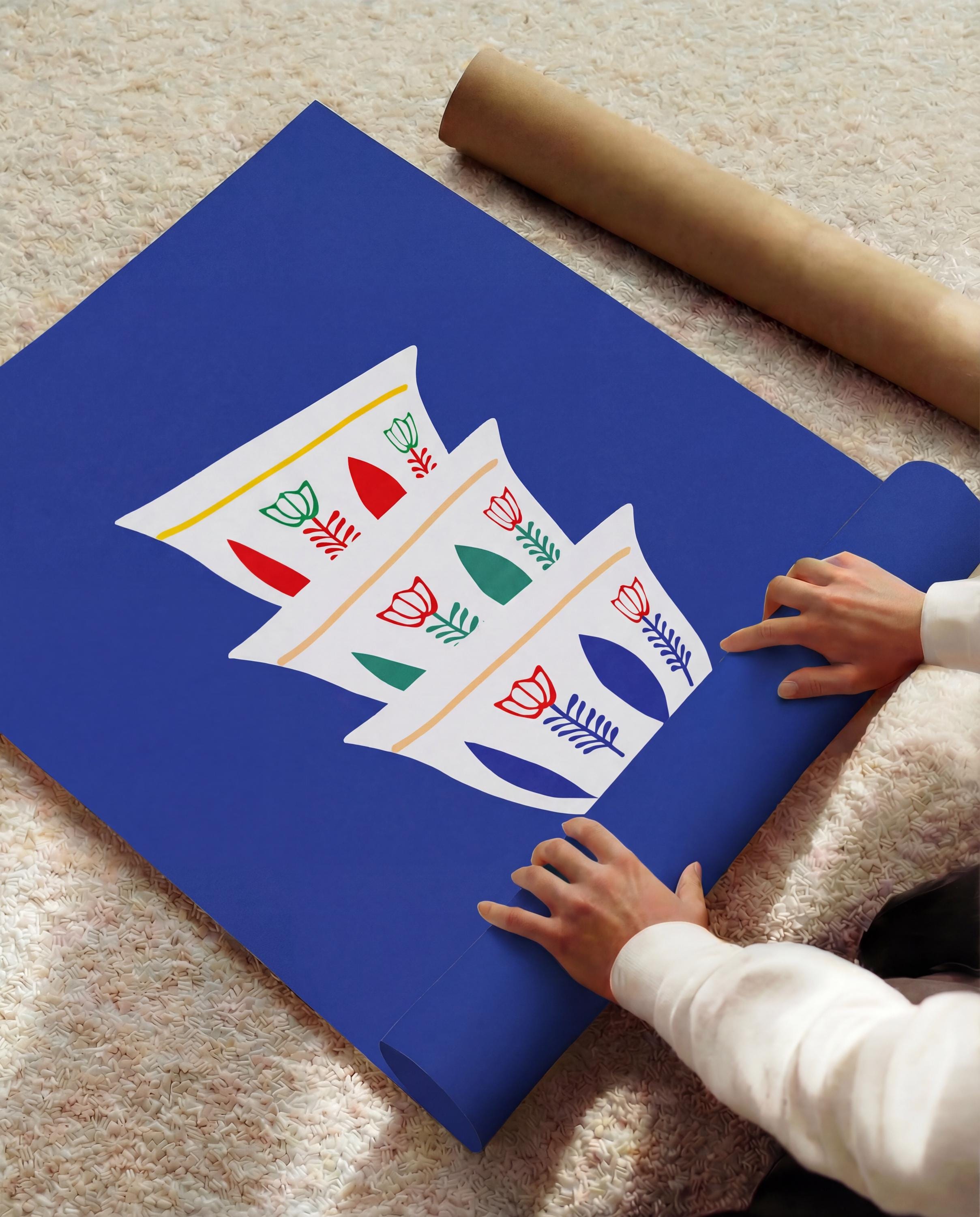 A rolled blue poster with a white graphic of stylized coffee cups with red, green, and yellow floral designs. A brown paper tube is visible in the background. The poster is being unrolled.